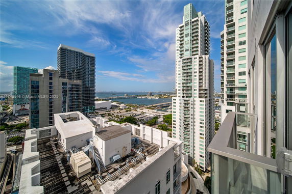 View of city buildings and a body of water from a high vantage point.