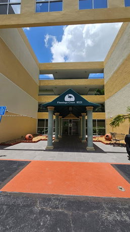 Front view of a building entrance with a covered walkway.