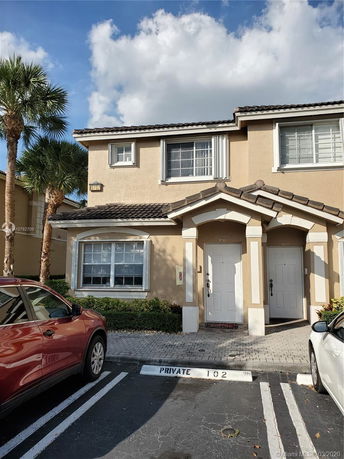 Front view of a two-story house with a gabled roof.