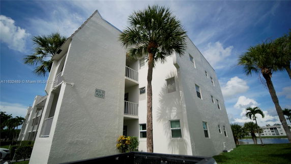 Front view of a multi-story residential building with balconies.