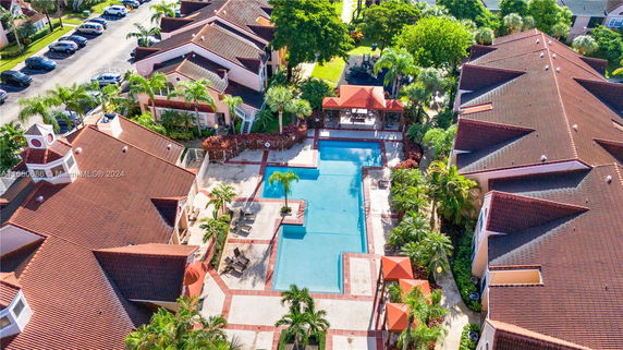 Aerial view of a residential complex with a central swimming pool.