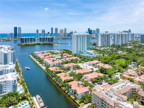 Panoramic view of a modern cityscape with high-rise buildings and waterways.