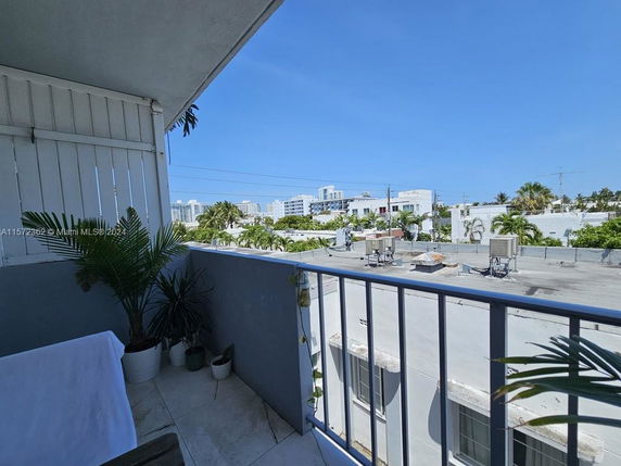 View from a balcony overlooking rooftops and nearby buildings.