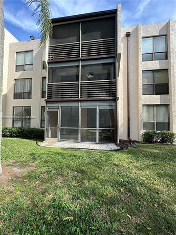 Front view of a multi-story building with screened balconies.