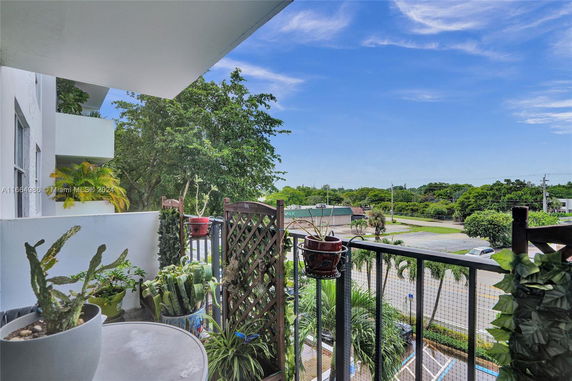 View of surrounding areas from a balcony with plants.