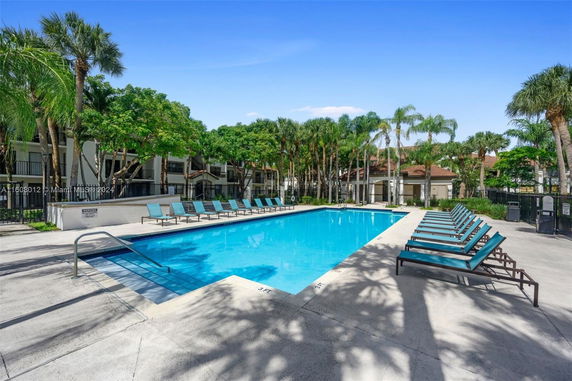 Outdoor area with a swimming pool and lounge chairs.