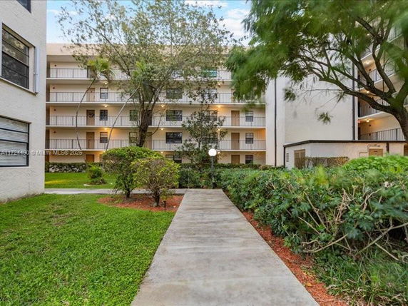 Front view of a multi-story apartment building with balconies.