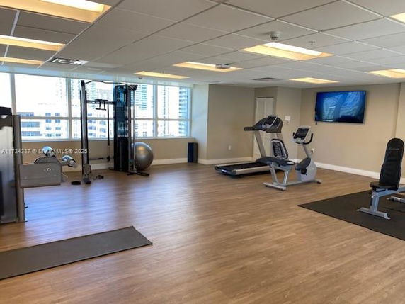Interior view of a gym area with exercise equipment, including treadmills and weight machines.