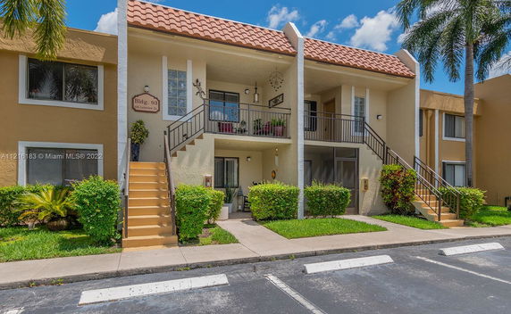 Front view of a multi-story residential building with two sets of stairs.