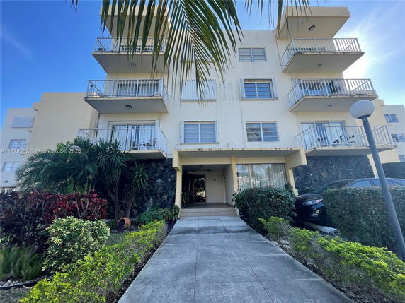 Front view of a multi-story residential building with balconies.