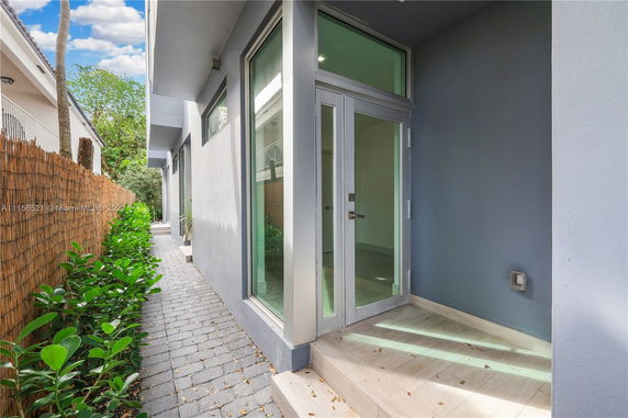 Front view of a modern house with a glass door entrance.
