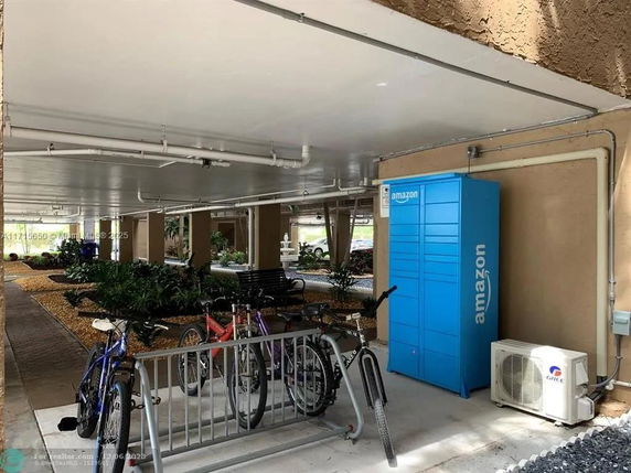 Covered outdoor area with bike rack and storage locker.