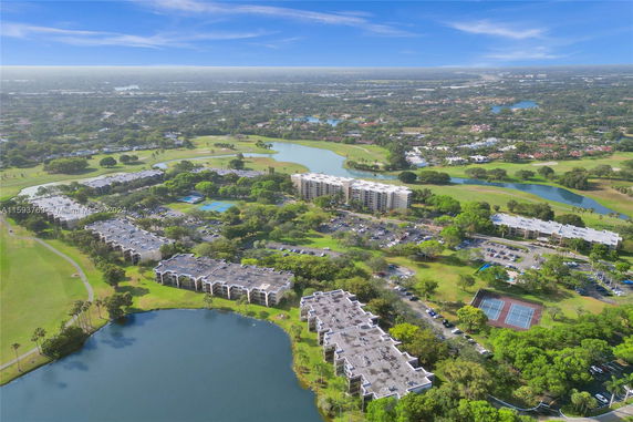 Panoramic view of buildings surrounded by greenery and water bodies.