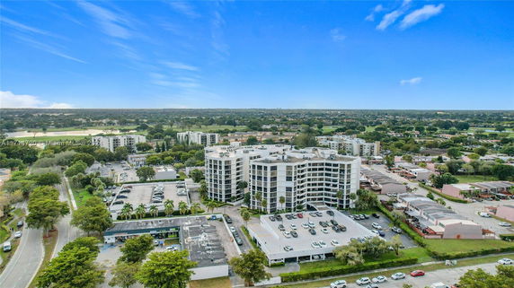 Aerial view of a residential complex with multiple multi-story buildings surrounded by roads and greenery.