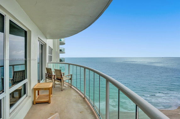 Balcony view overlooking the ocean from a high-rise building.