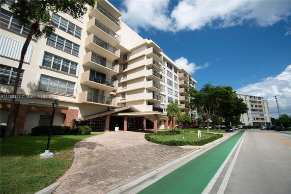 Front view of a multi-story residential building with balconies.