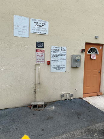 Wall with signs near an entrance door.