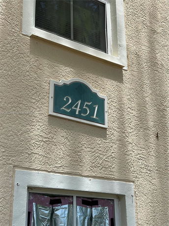 Close-up view of the building's exterior with a visible address number 2451.