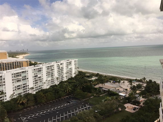 Panoramic view of a coastal area with residential buildings and the ocean.