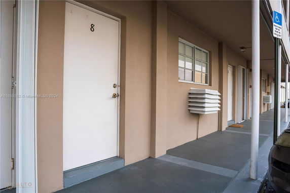 Front view of a multi-unit building with numbered doors.