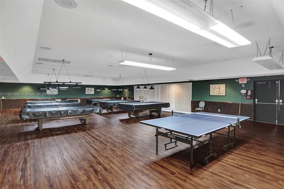 Indoor recreational area with billiards and table tennis tables.