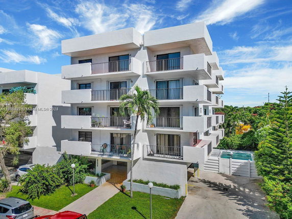 Front view of a multi-story apartment building with balconies
