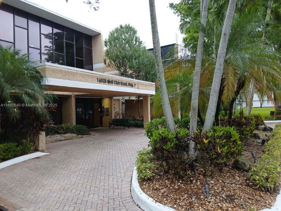 Front view of a building with large windows and a covered entrance.