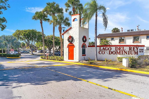 Front view of a condominium entrance with holiday decorations.