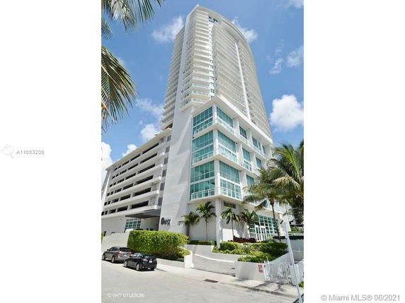 Front view of a high-rise building with large glass windows.