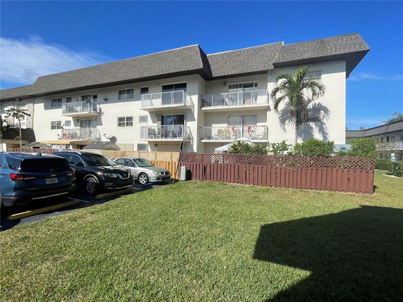 Front view of a multi-story residential building with balconies.