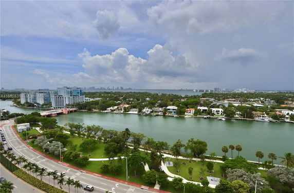 Panoramic view of a waterfront area with a bridge and buildings in the distance.
