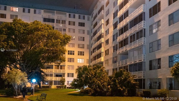 Rear view of a multi-story residential building with balconies.