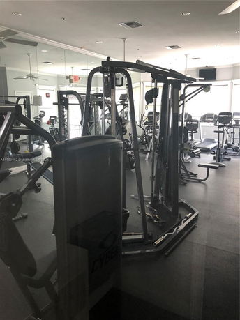 Interior view of a gym with exercise machines and cardio equipment.