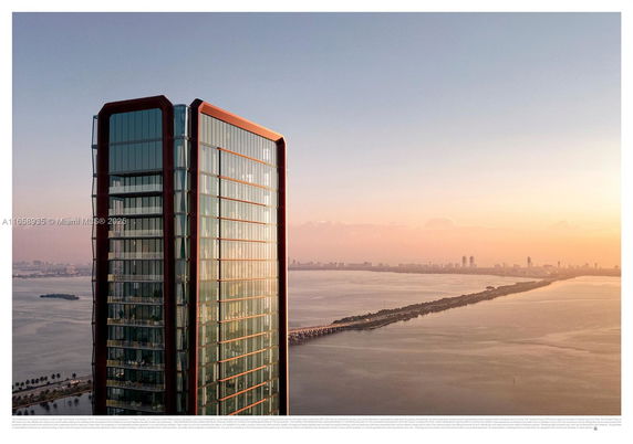 Elevated view of a modern high-rise building with glass facades, overlooking a body of water and city skyline.