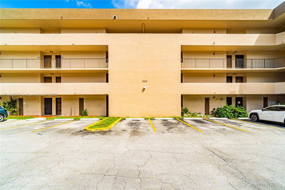 Front view of a multi-story apartment building with balconies.
