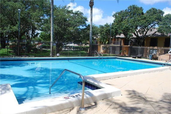 Outdoor swimming pool with surrounding trees.