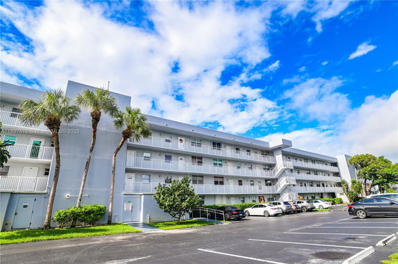 Front view of a multi-story residential building with balconies.
