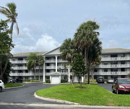 Front view of a multi-story residential building with balconies.