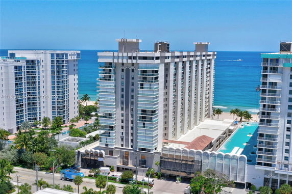 Front view of a high-rise building near the ocean.