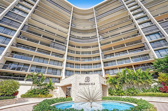 Front view of a multi-story residential building with balconies.