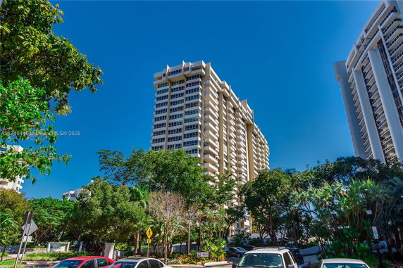 Front view of a high-rise residential building with balconies.