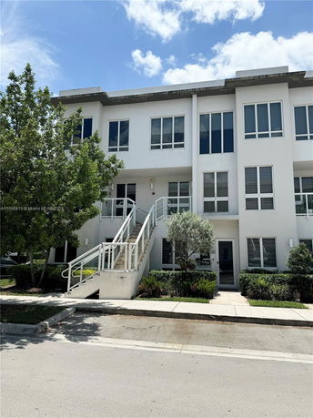 Front view of a two-story modern white building with large windows.