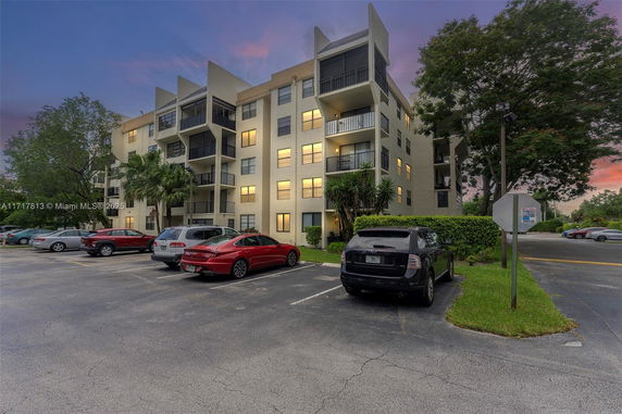 Front view of a multi-story residential building with balconies.
