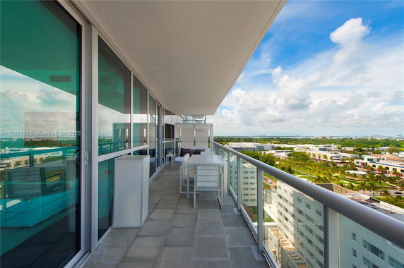 Balcony of a high-rise building with a wide view of the cityscape.