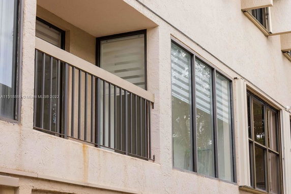 Exterior view of a building with large windows and a small balcony.