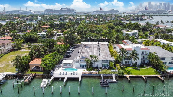Panoramic view showing waterfront properties and cruise ships in the background.