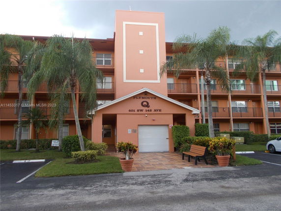 Front view of a multi-story apartment building with balconies.
