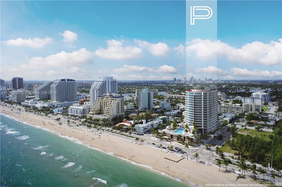 Aerial view of beachfront buildings and cityscape.