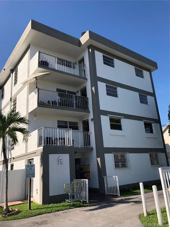 Front view of a multi-story residential building with balconies.