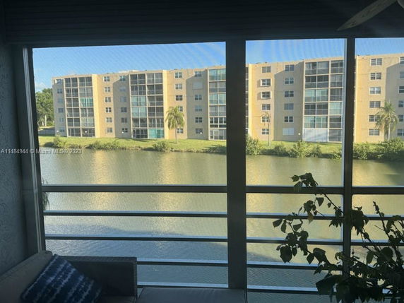 View from a building overlooking a water body with apartment buildings in the background.